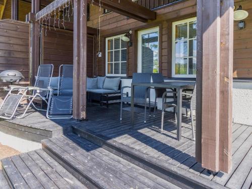 a porch with chairs and a table on a house at Holiday Home Tahkon klubitie 4 a by Interhome in Tahkovuori