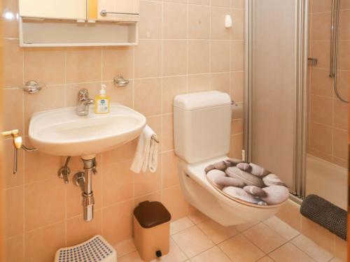 a bathroom with a toilet and a sink and a shower at Apartment Cascades d'Eden 2 by Interhome in Crans-Montana