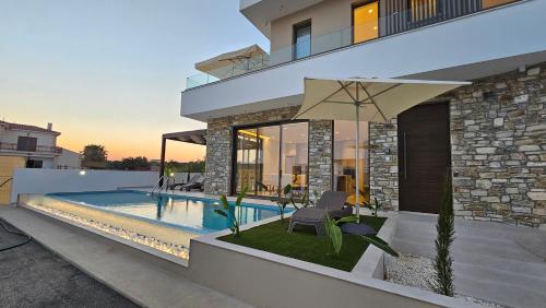 a house with a swimming pool in front of it at STAY Oasis Luxury Villas in Ayia Napa