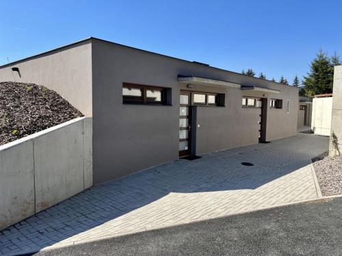 a house with a garage with a driveway at Holiday Home Říčky F38 by Interhome in Říčky