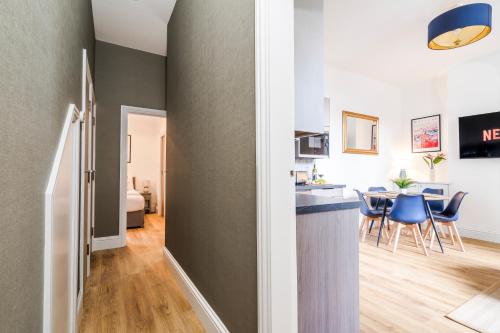 a kitchen and living room with a table and chairs at Cozy 2 Bedroom Apartment in Sutton in Sutton