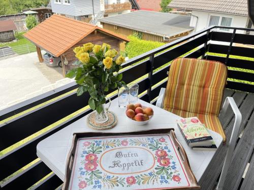 a table with a vase of flowers on a balcony at Apartment Wichtelmännchen by Interhome in Dittishausen