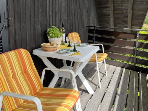 a white table and two chairs on a patio at Apartment Wichtelmännchen by Interhome in Dittishausen