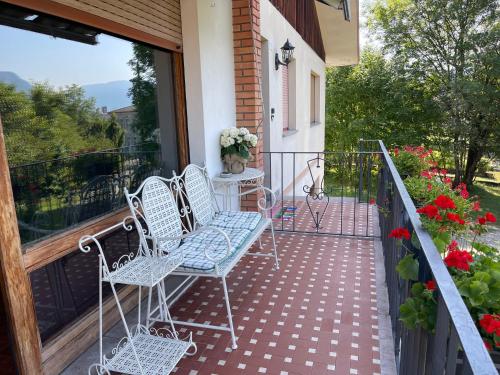 two chairs and a table on a balcony at Villa Debora in Ponte nellʼAlpi