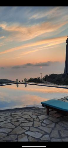 a swimming pool with a bench next to the water at Sun Castle Houses in Drymon