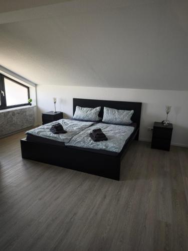 a bedroom with a large bed with two night stands at Villa Levilia in Strullendorf