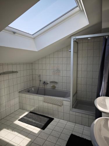 a bathroom with a tub and a sink at Villa Levilia in Strullendorf