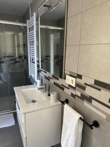 a bathroom with a sink and a mirror at PIPER ETXEA. Relax, mar y monte! in Mutriku