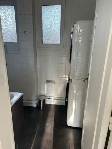 une cuisine avec un réfrigérateur blanc dans une pièce dans l'établissement Au parc, à Tourcoing