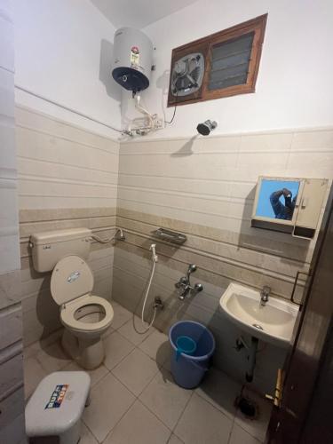 a bathroom with a toilet and a sink at Nanda Mohan Homestay- Luxuries AC Apartment close to Alipiri Foothills-Kapila Teertham and ISKCON temple in Tirupati