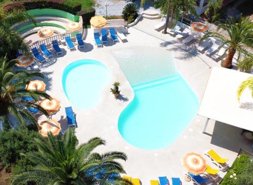 an overhead view of a swimming pool at a resort at Costa Real - Garden Retreat with Private beach, Pet Friendly in Capo Vaticano