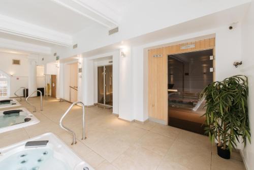 a large bathroom with a tub in the middle at The Headland Hotel & Spa in Torquay