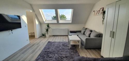 a living room with a couch and a tv at Bonn/Königswinter ferienwohnung in Königswinter