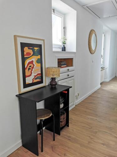 un bureau avec une lampe et une chaise dans une pièce dans l'établissement L'éclat urbain, à Chambéry