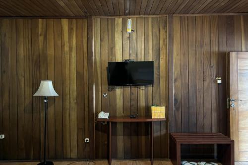 a corner of a room with a television on a wall at Hotel Pesona Bamboe Lembang in Genteng