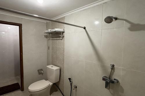 a bathroom with a toilet and a shower at Hotel Pesona Bamboe Lembang in Genteng