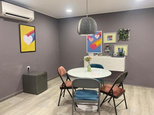a dining room with a table and chairs at Aurora Court Service Apartment in George Town