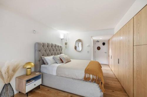 a bedroom with a large bed with a large headboard at Pacific Chic Luxury Pad - Beachfront Aircon Lift in Sydney