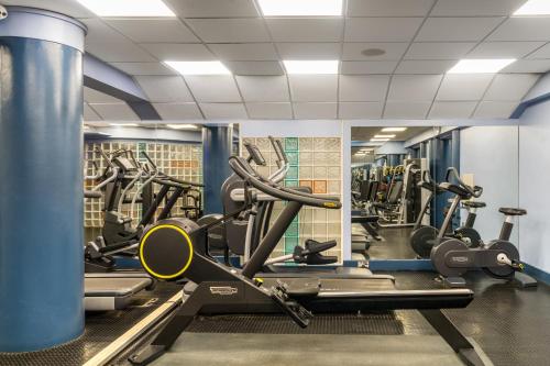 a gym with several treadmills and cardio machines at The Palace Hotel in Paignton