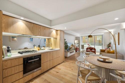a kitchen and living room with a table and chairs at Pacific Chic Luxury Pad - Beachfront Aircon Lift in Sydney