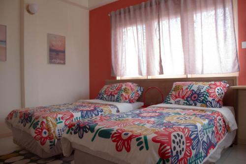 a bedroom with two beds and a window at Aurora Court Service Apartment in George Town