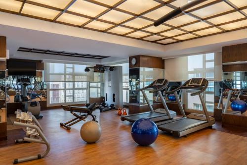 a gym with several exercise equipment in a room at Anwar Al Madinah Mövenpick in Al Madinah
