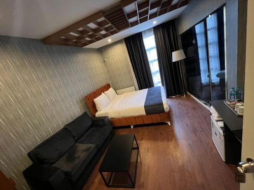 a hotel room with a bed and a couch at Beta Hotel Avcılar in Avcılar