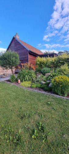 a house with a garden in front of it at Apartmány Moravia in Milovice