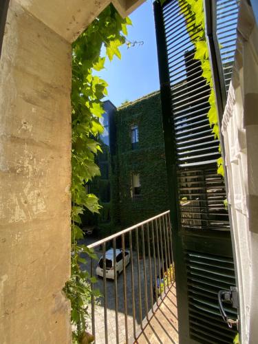 an open gate to a building with a car on the street at Palazzo Rollo in Lecce