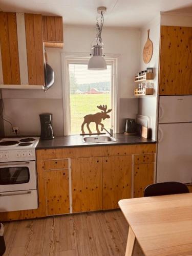 a kitchen with a deer statue on the counter at Rödvattnet cottages in Rödvattnet