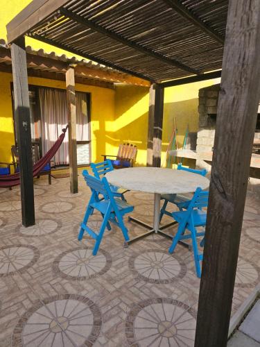 a table and chairs in a room with a playground at Mirador del Diablo in Punta Del Diablo