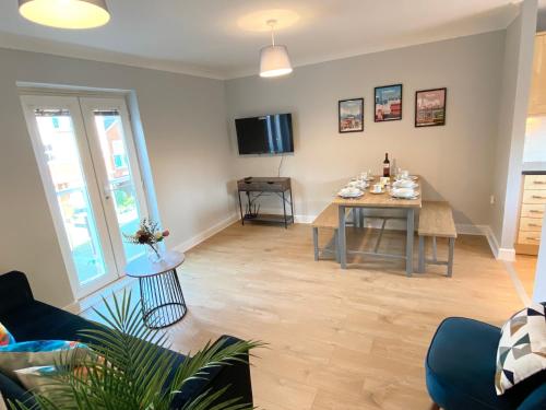 a living room with a table and a dining room at 2 Bedroom Flat near Redhill train station, easy access to Gatwick & London in Redhill