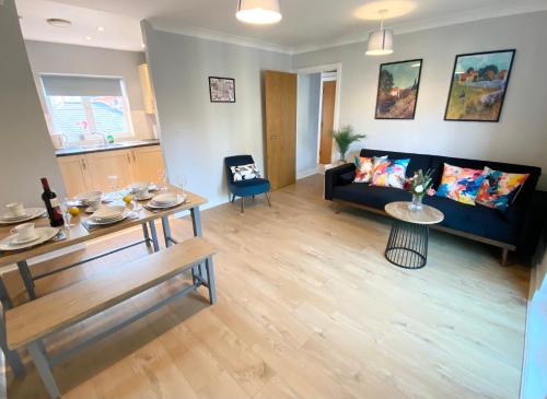 a living room with a couch and a table at 2 Bedroom Flat near Redhill train station, easy access to Gatwick & London in Redhill