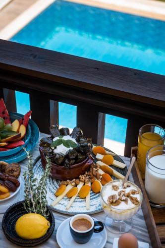 a table with a buffet of food and a pool at Akron Seascape Resort by Anayia All Inclusive Resorts in Sidari
