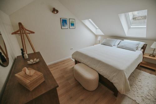a small bedroom with a bed and a table at Stone House Zrinski entire apartment 62 m2 in Luka