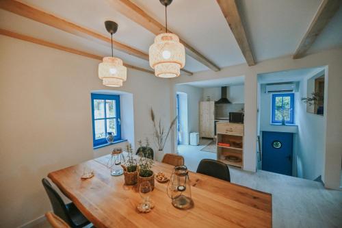 a kitchen and dining room with a wooden table at Stone House Zrinski entire apartment 62 m2 in Luka