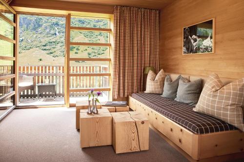 salon z dużą kanapą i stołem w obiekcie abitare chalets w mieście Obergurgl