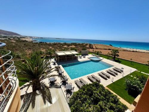 a view of a swimming pool and the beach at Pachia Ammos Falasarna in Falasarna