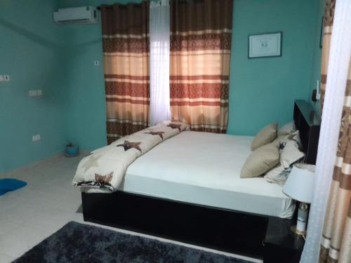 a bed in a room with a window and a bed sidx sidx sidx at Matata Homes Airbnb in Kasoa