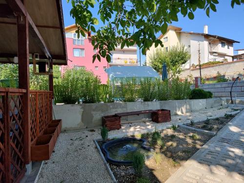 a garden with a pond in the middle of a building at Guest House 51 in Kranevo