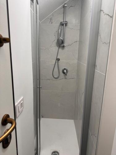 a bathroom with a shower with a glass door at Suite Aurora in Crotone