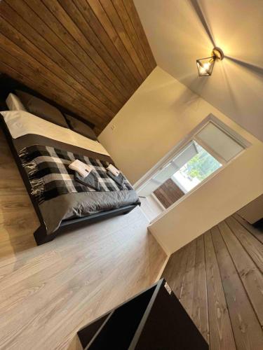 a bedroom with a bed and a window on the floor at Готель WeLKoMe in Krivorovnya