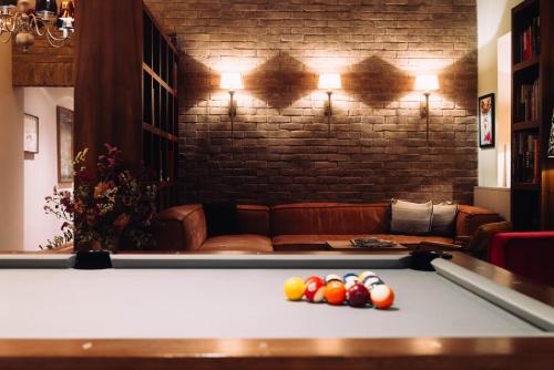 a billiard table with balls on top of it at Cortisen am See - Adults only in St. Wolfgang