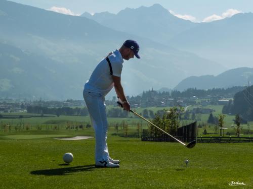 a man hitting a golf ball with a club at Der Siegeler B&B - this lifestylehotel rocks in Mayrhofen
