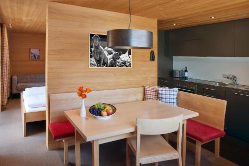 a kitchen with a table with a bowl of fruit on it at abitare chalets in Obergurgl