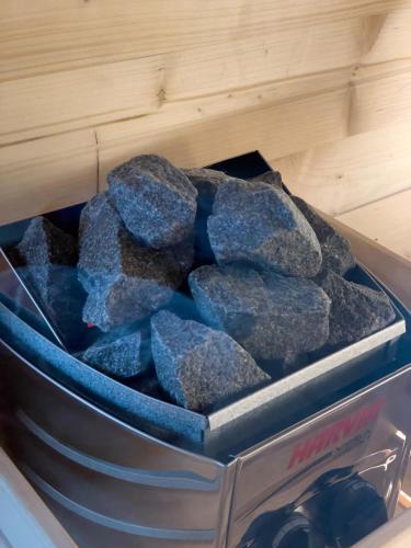 a container full of rocks in a drawer at Vivi la Magia di Bisdalù - Dormi nella Stanza nel Bosco, Ammira le Stelle e Rilassati con l'Area Benessere e Colazione in Peveragno