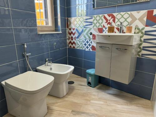 a bathroom with a toilet and a sink at Napul'è B&B in Boscotrecase