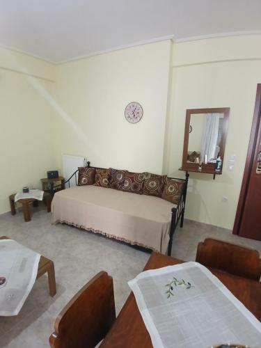 a bedroom with a bed and a mirror on the wall at Ελένης apartment in Gythio