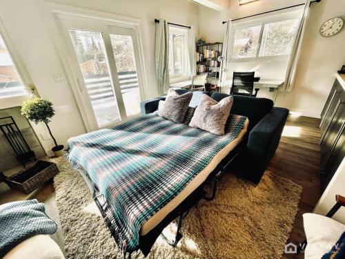 a living room with a bed and a couch at Aspen Alcove - Amazing Views Private Hot Tub in Park City