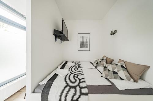 a bedroom with a bed with a black and white comforter at City Center Lofts in Vienna